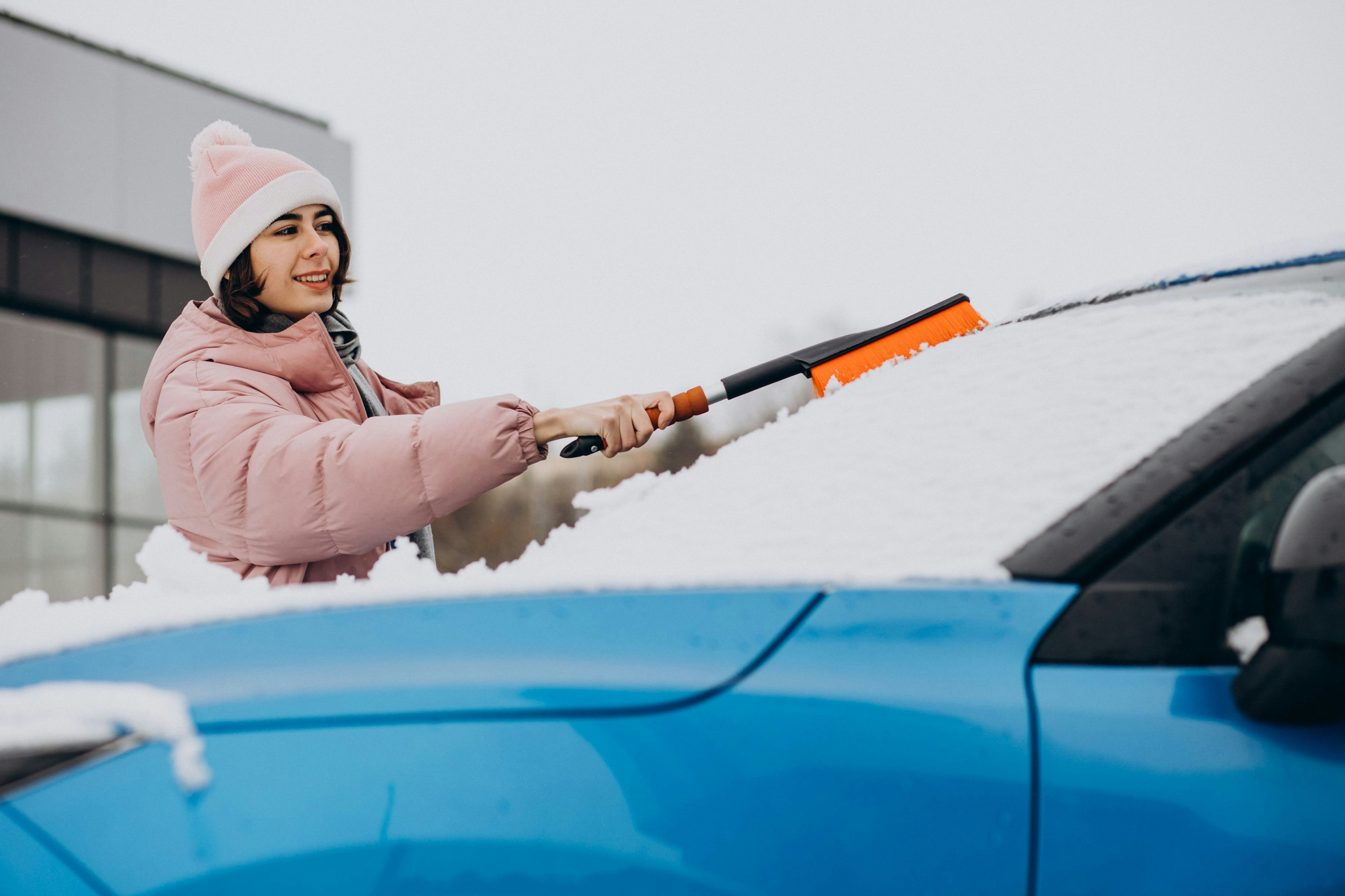 woman-cleaning-her-window-car-from-snow.jpg